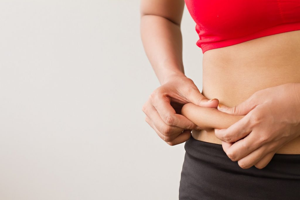 Woman pinching her tummy