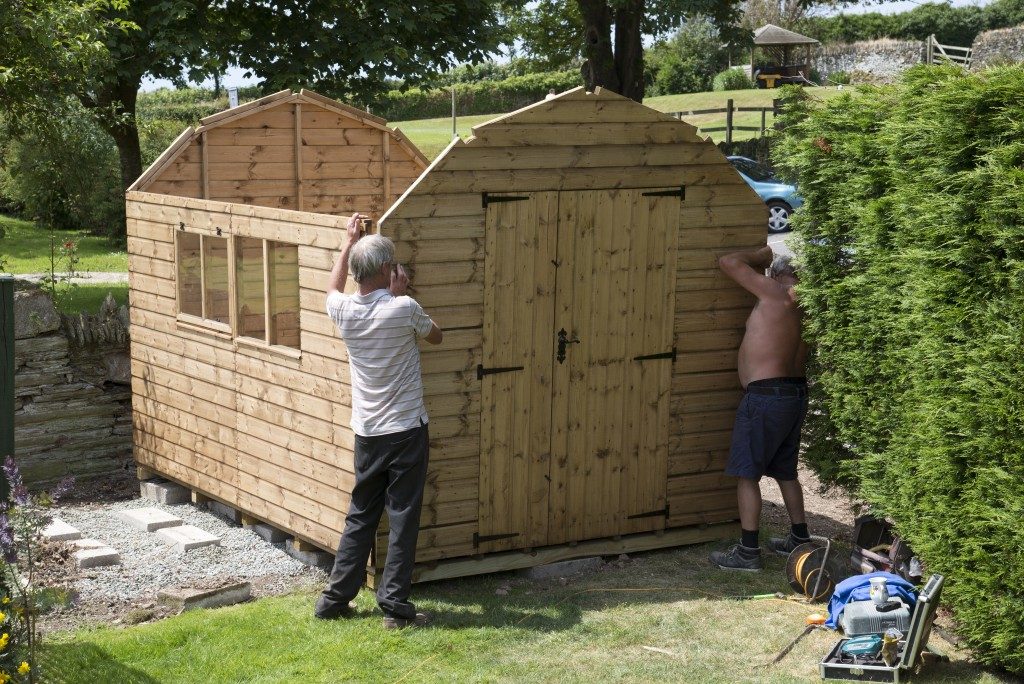 Wooden shed installation in the backyard