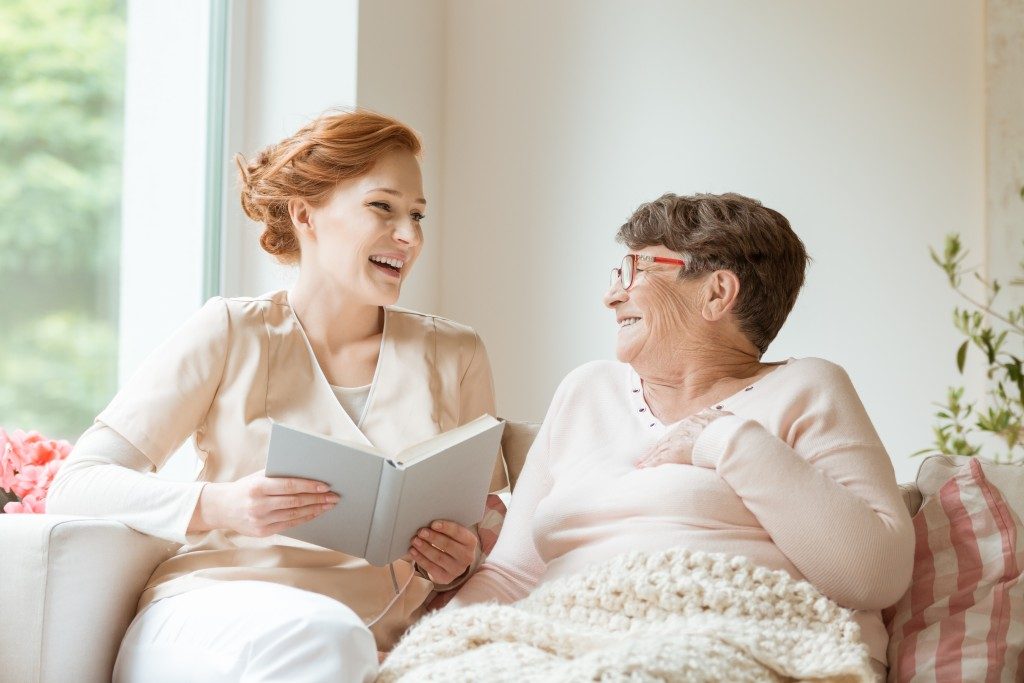 Nurse reading with elderly patient