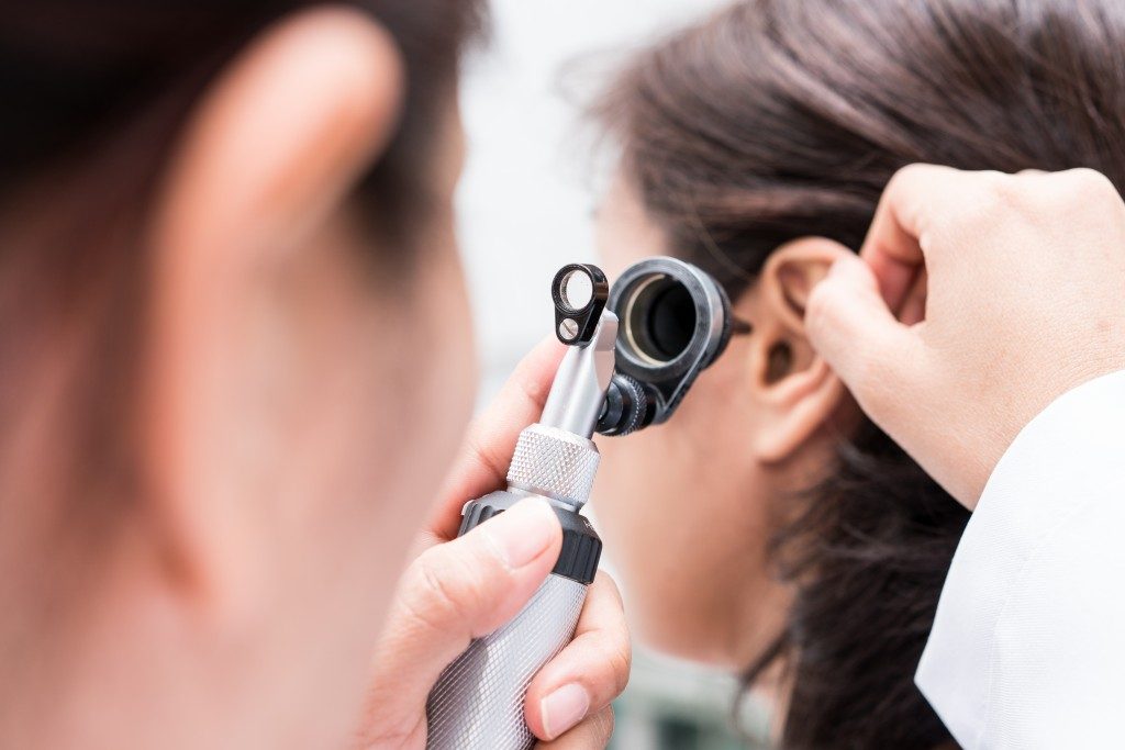 Doctor examining the patient's ear