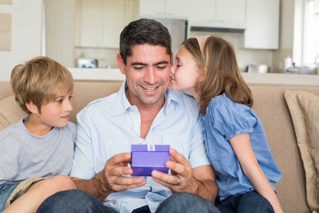 Kids giving their dad a gift