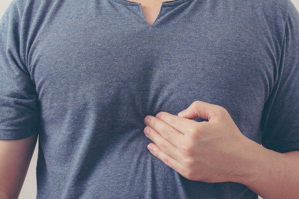 Close up of man having acid reflux