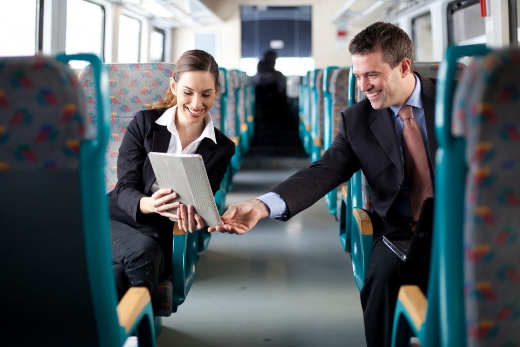 two executives riding a train