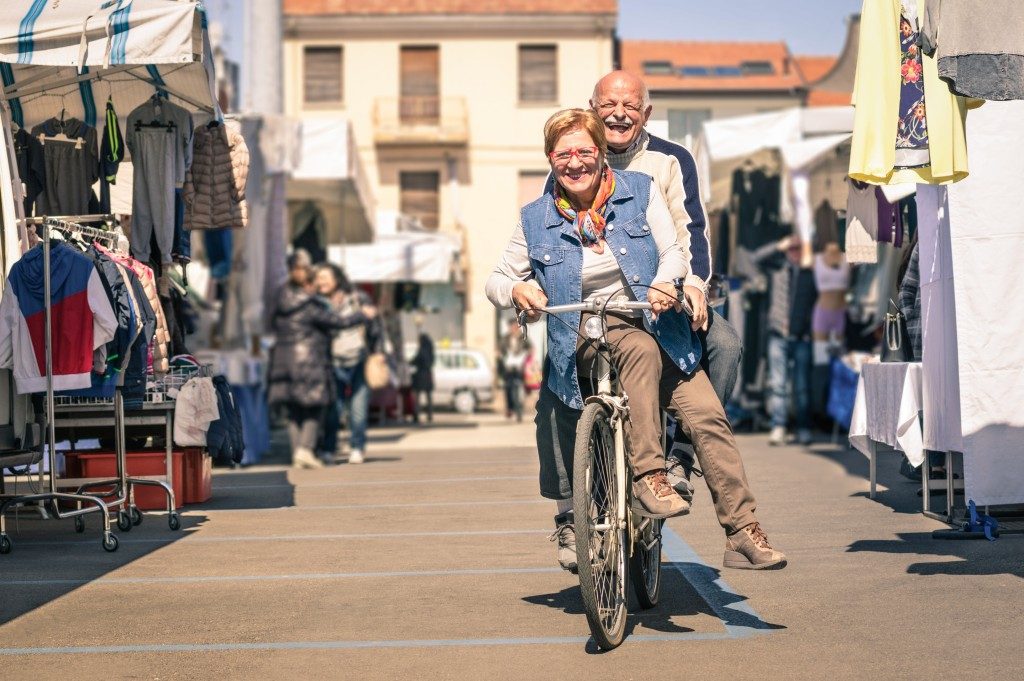 senior couple having fun with bicycle