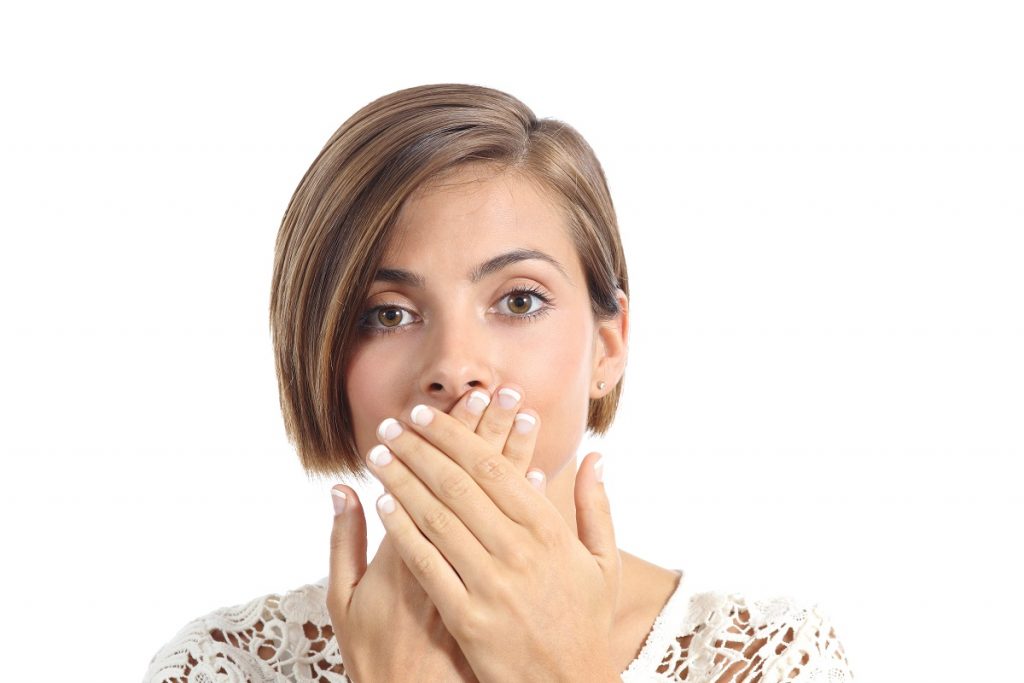 Woman covering her mouth