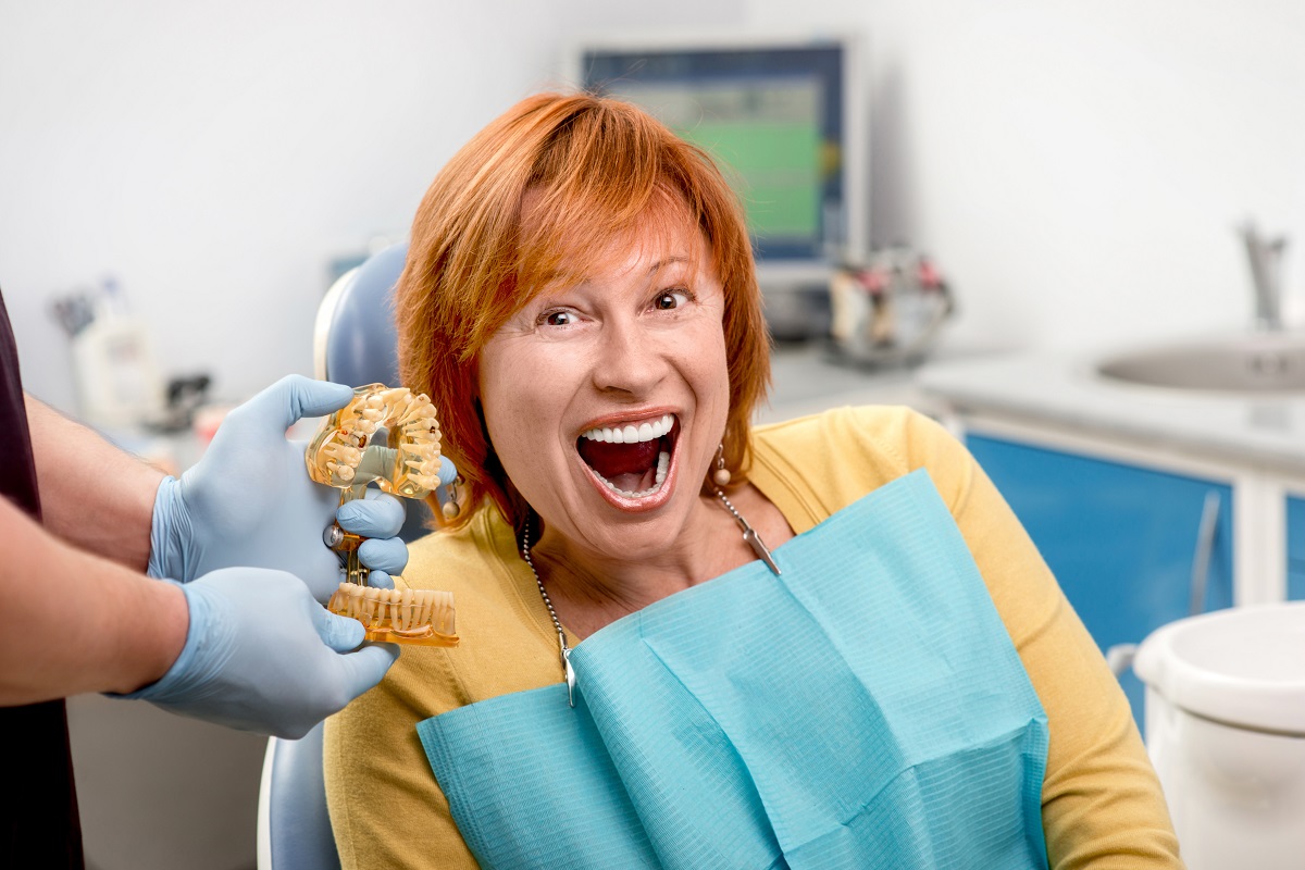 woman smiling with her teeth mold
