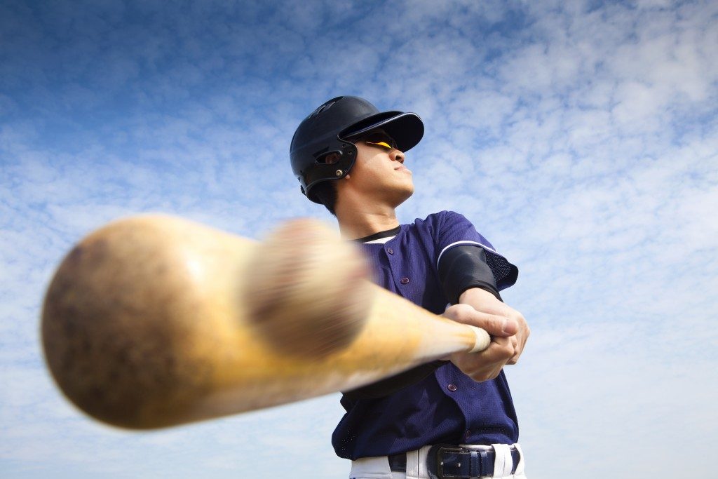 Man hitting the ball with a bat