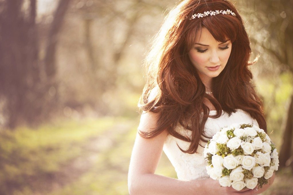 Woman in her wedding dress in a garden background