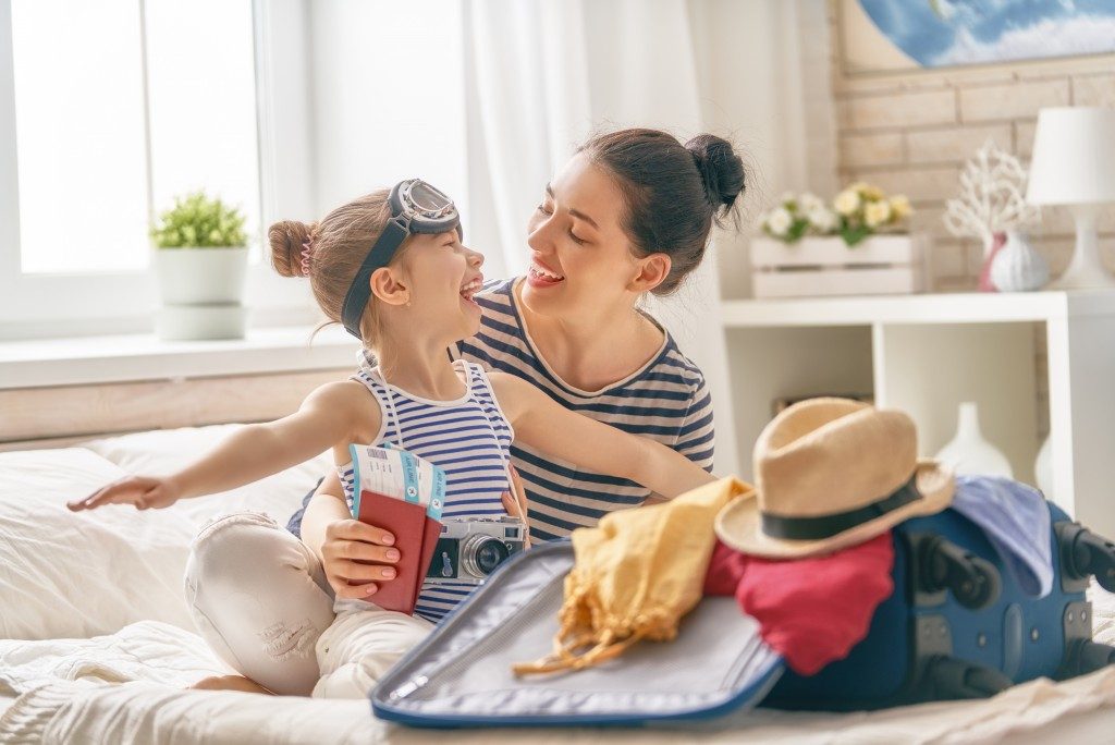 mom and kid packing for a trip