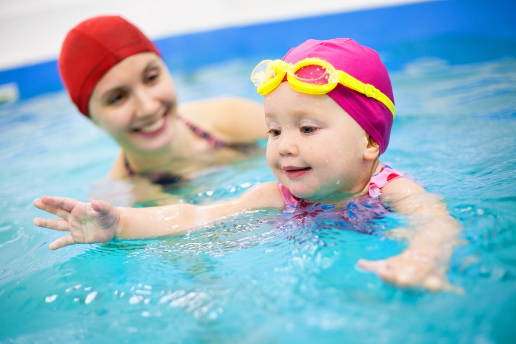 toddler and mom in swimming pool