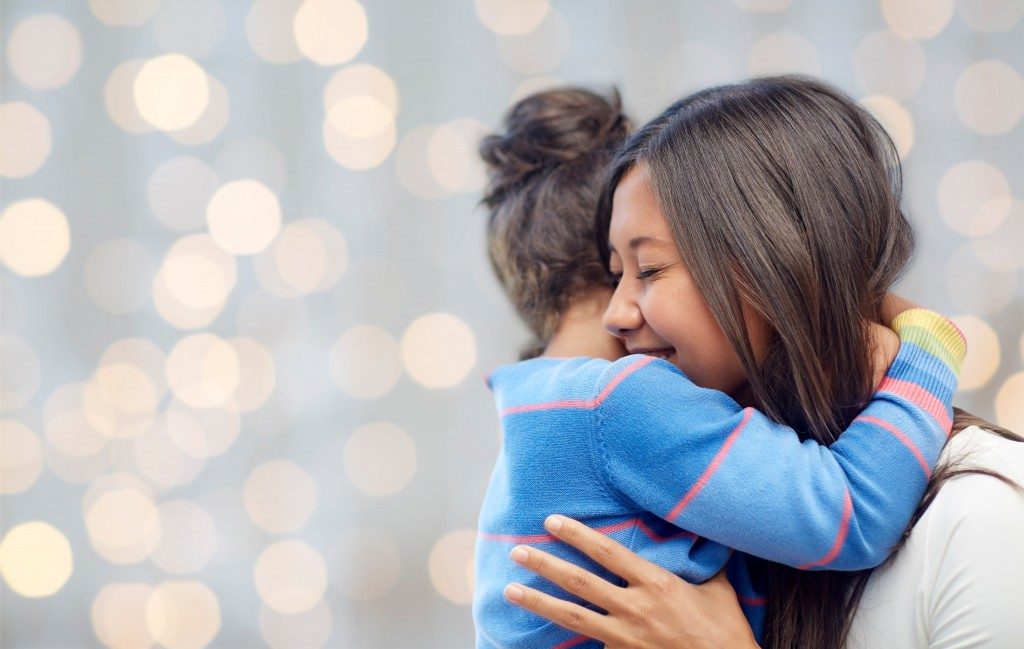 mother hugging child