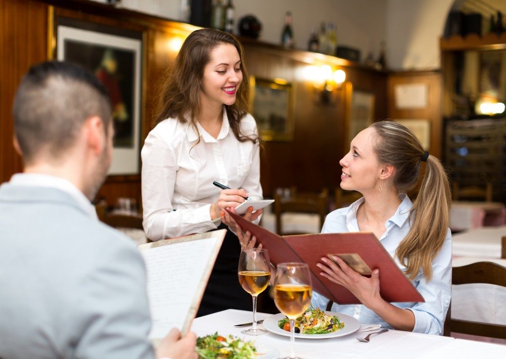 waiter taking the customer's orders in a restaurant