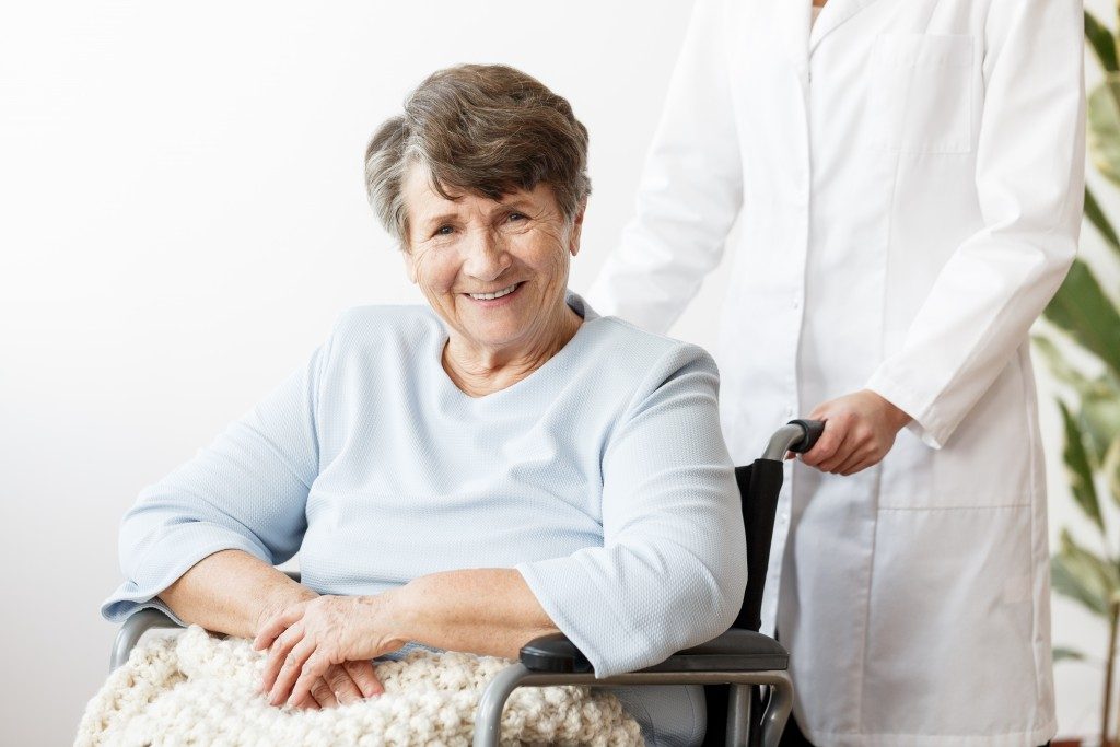 senior in a wheelchair with caretaker