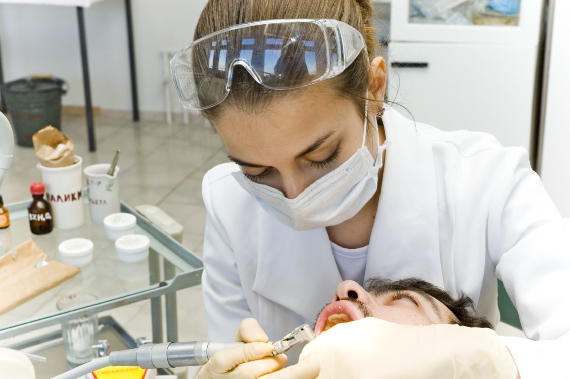 Dentist and patient having a dental procedure