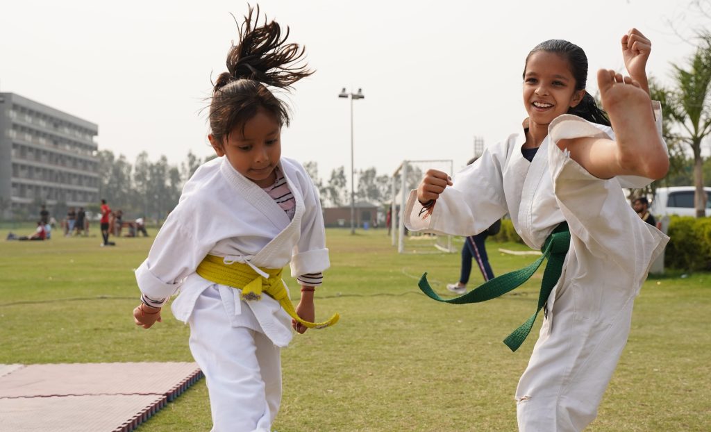 Two children doing kicks