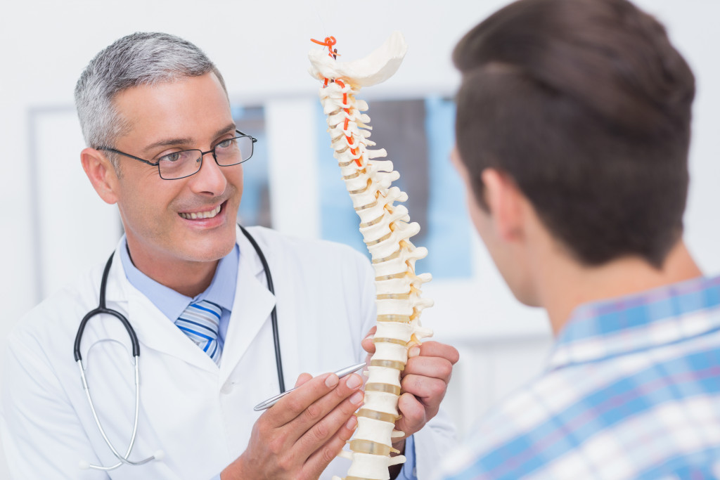 doctor showing spine to patient