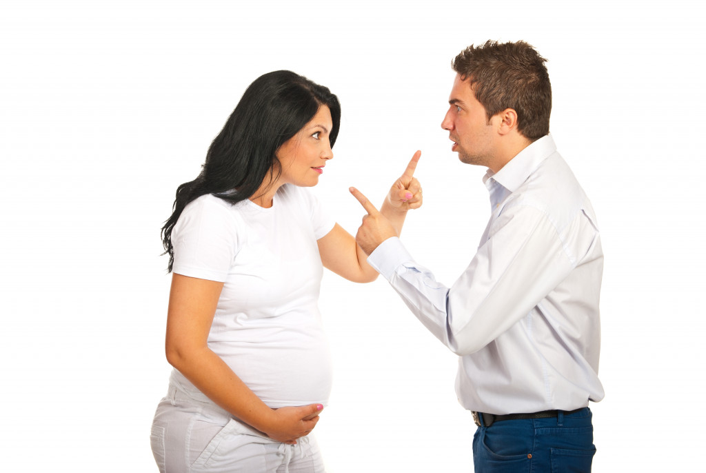 A pregnant woman arguing with partner