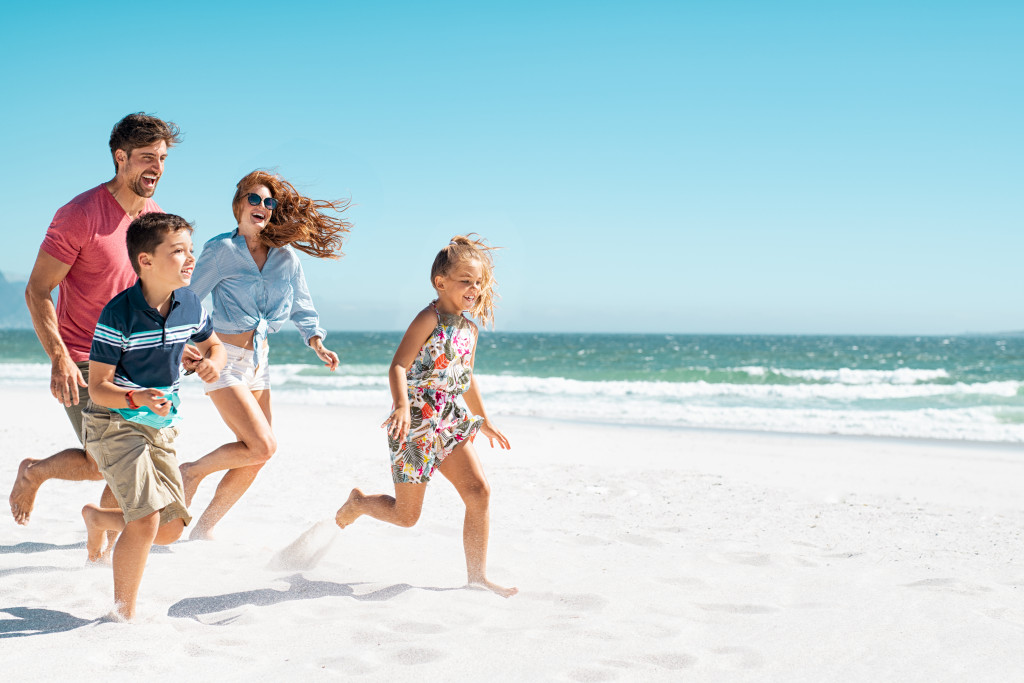 A happy family running on the beach